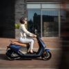 Segway e-Scooter E125S Lifestyle Girl riding in motion side view